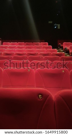 
A neat arrangement of red seats in the cinema.