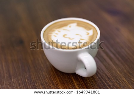 A cup of coffee with a picture of a cat