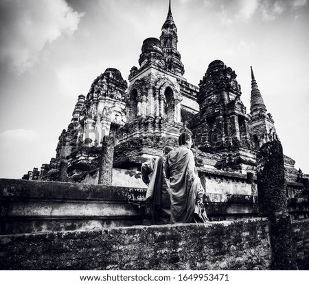 Monk for Visit Buddhist Temples at Unesco  heritage Historical Park Sukhothai Thailand .Monk Pay respect  Buddha in black and white tone . Thailand Temple Etiquette