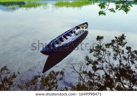 the canoe is above the clear water like a mirror