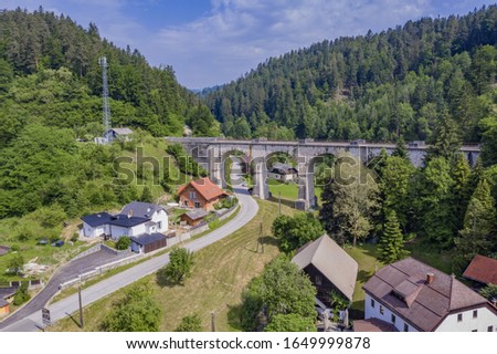 An aerial shot of the Stoparjev bridge in Slovenia surrounded by trees