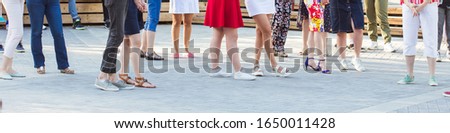 Social dance and flashmob concept - Fun and dance with in the summer on a city street. Close-up of dancers feet.