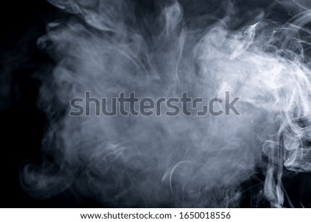 Abstract, White haze Floating in the Air over a Black Background