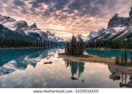 Traveler canoeing with rocky mountain reflection on Maligne lake at Spirit island in Jasper national park, Canada Royalty-Free Stock Photo #1650032650