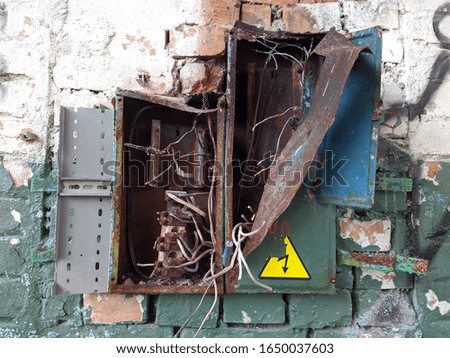 broken rusty electronic shield with wires in an old abandoned building closeup photo