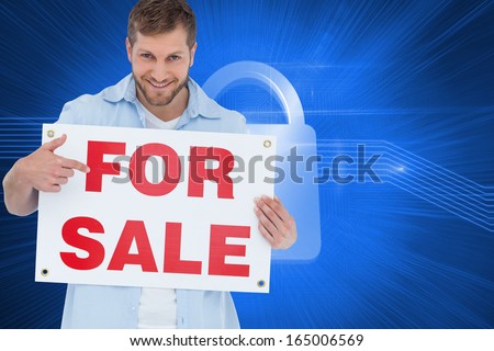 Composite image of smiling model holding a for sale sign