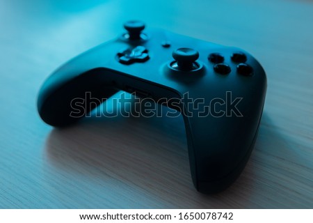 Computer game competition. Gaming concept. Top view of a joystick on wooden planks