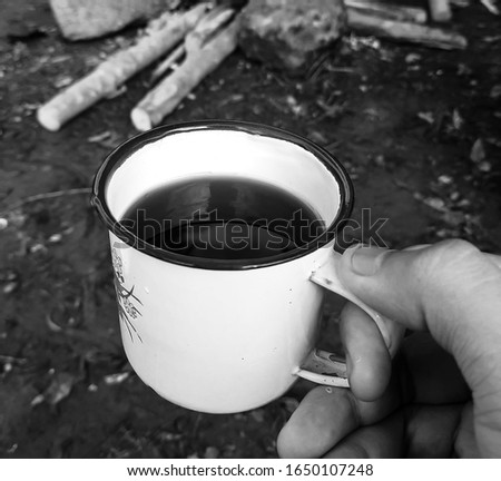 coffee in tin cup. Black-white photo