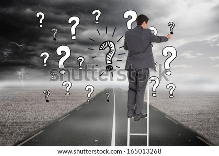 Composite image of businessman standing on ladder writing