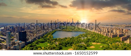 Aerial view of Manhattan New York looking south up Central Park during epic sunset over the city.