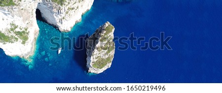 Aerial drone ultra wide photo of iconic rock formation of Ortholithos in island of Paxos, Ionian, Greece