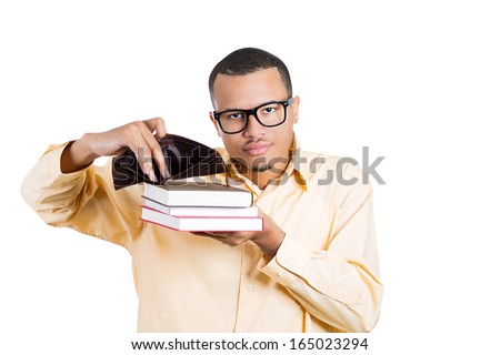 Closeup portrait of young student man holding books in one hand and empty wallet in the other, looking distressed that he has no more money is broke, isolated on white background. Education value