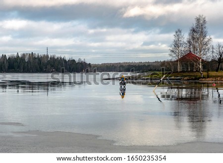 Сyclist rides on the thin ice of Lake Saimaa in Lappeenranta. Finland