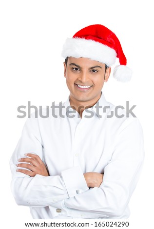 Closeup portrait of handsome smiling confident young man crossing folding arms in front of chest wearing red santa claus hat, isolated on white background. Positive emotion facial expression