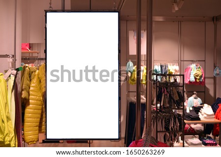Blank showcase billboard for your text message or media content with blurred image popular fashion clothes shop.