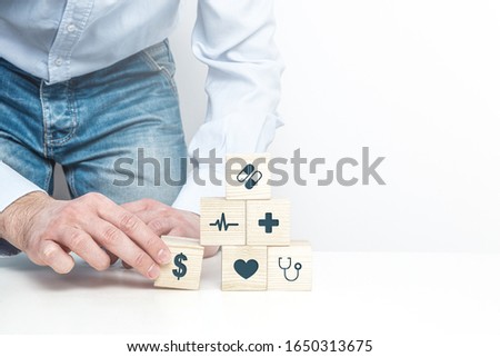 Medical symbols on wooden blocks. Medical and pharmaceutical concept. Health insurance, validity of money during treatment, financial and health problems.