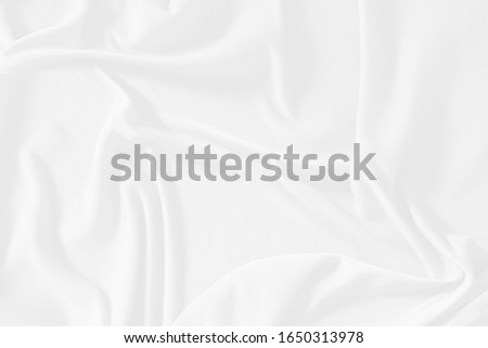 White cloth background abstract. Fabric is wrinkled and sofe wave. Material are used in textile assembly. detail texture of pattern design, elegance with free space copy for backdrop or wallpaper.