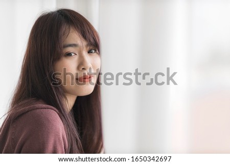 Portrait of beautiful young Asian woman is smiling in bed.
