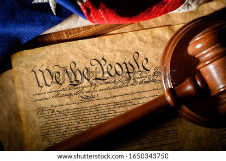 The American constitution, a gavel, and the United States flag Royalty-Free Stock Photo #1650343750
