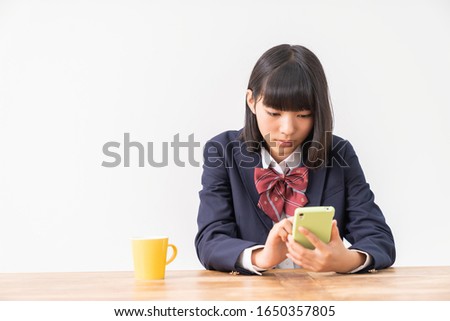 asian girl student using smart phone,School uniform,