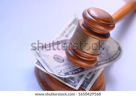 close up of gavel, cash and book on table 