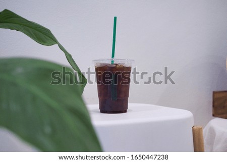 A beautiful ice black coffee served with plastic glass. Selective focus. blur background