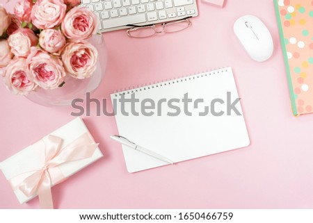 Notebook mock up,pink roses flowers,gift box top view on pink background flat lay. Copy space.  Holiday, birthday concept