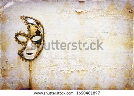 elegant traditional venetian mask over distressed old white wooden background