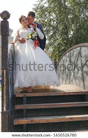married couple, happy bride and groom kiss in the park