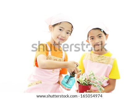 Smiling girls with plant