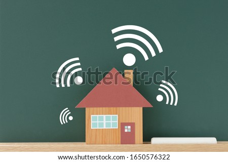 House object and wi-fi image illustration on black board