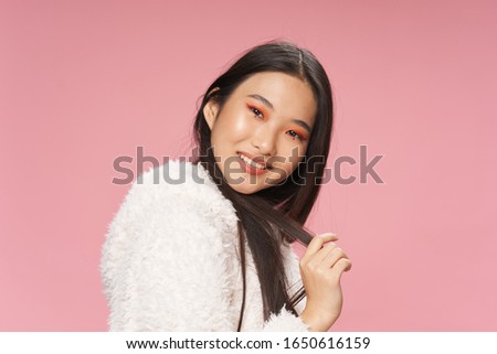 Beautiful woman pink background make-up dark hair smile