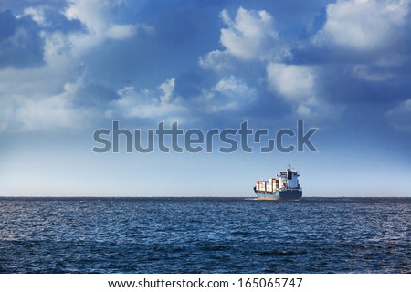 cargo ship in the ocean in the sky Royalty-Free Stock Photo #165065747