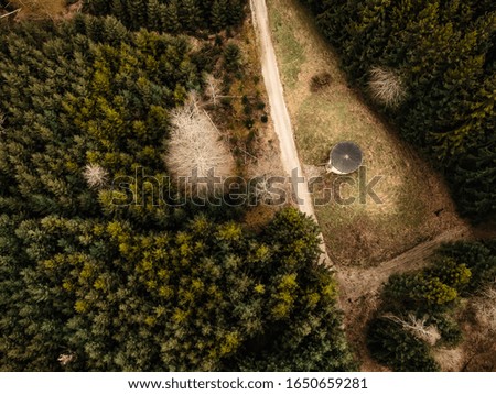 Drone photography of water reservoir within a rural forest