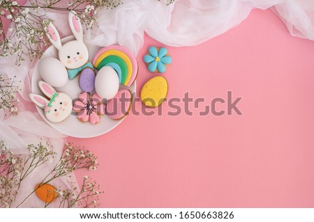 Happy Easter. Multi-colored pastel easter cookies on a pink background. Easter concept
