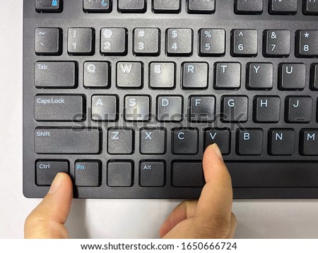 A thumb finger and pointer finger press simultaneously on keyboard at “Ctrl” key with “V” key.It is shortcut key to paste. Royalty-Free Stock Photo #1650666724