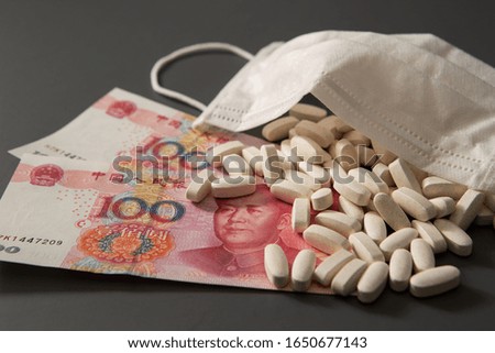 Chinese paper currency, face mask and medicine 