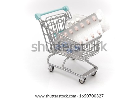 Funny photograph of a hypermarket cart carrying many medicines, it tells us how bad its abuse is and criticizes that it is taken as if it were food, on white background, isolated, product photography