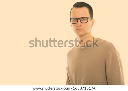 Studio shot of young handsome man wearing eyeglasses