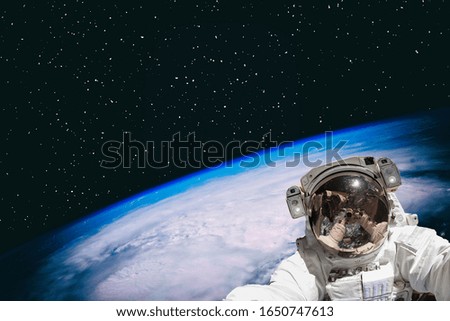 Astronaut and the earth. The elements of this image furnished by NASA.
