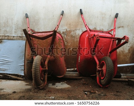 Old and  new red wheelbarrow 