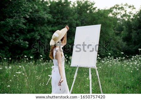 woman model paints a picture on canvas