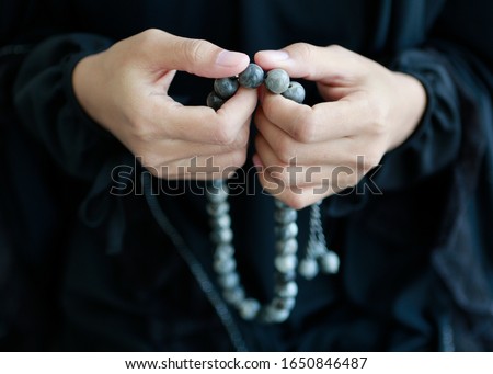 Islamic women pray inside mosque by holding beads and count to Allah. Bangkok Thailand Northeast Asia Royalty-Free Stock Photo #1650846487