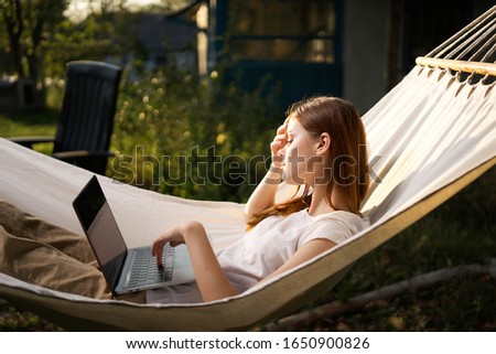 model woman with laptop outdoors