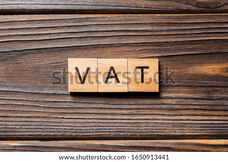 Vat word written on wood block. Vat text on table, concept.