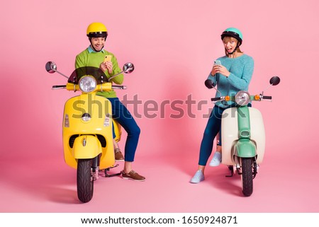 Full length photo of millennial lady guy two people sitting vintage moped vacation together short stop browsing telephone wear casual outfit headgear isolated pink color background