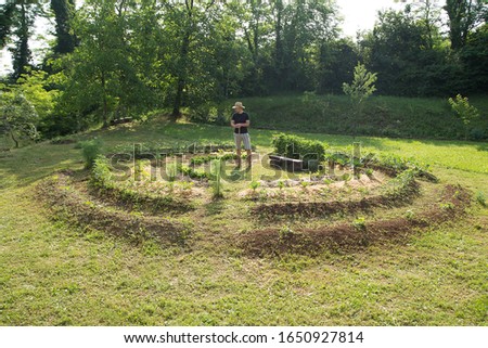 Young man with hat Working in a Home Grown Vegetable Garden
