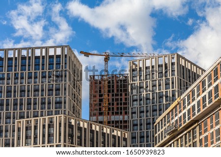 Construction of a modern residential complex. The construction of a multi-story building. cargo crane.city ​​new buildings.
