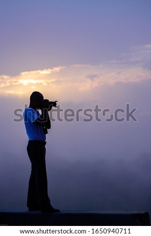 Male photographer photographed nature in the morning