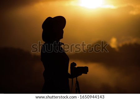 Female photographer shooting nature in the morning